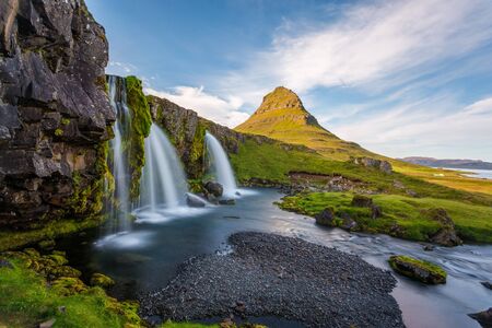 Kirkjufell Mountain, Snaefellsnes peninsula, Iceland. Landscape with waterfalls, long exposure in a sunny dayの写真素材