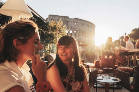Two smiling women at sunset in Rome, Italy. Happy Hourの写真素材