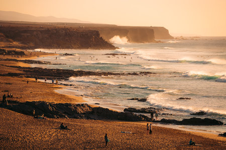 Stunning view of the El Cotillo beach with a rocky coastline in the distance.の写真素材