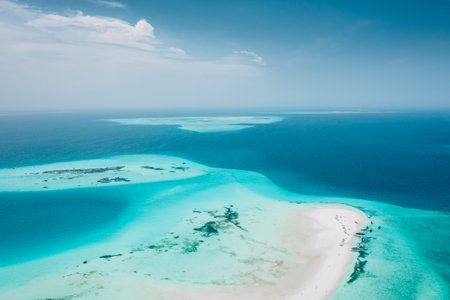 Zanzibar, Aerial view of turquoise lagoon, white sand beach, and boats.の写真素材