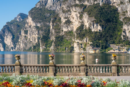 Riva del Garda, Italy: Scenic lakefront with flowers, mountainの写真素材