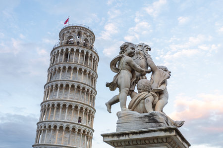Leaning Tower of Pisa and cherub statue, iconic Italian landmarksの写真素材