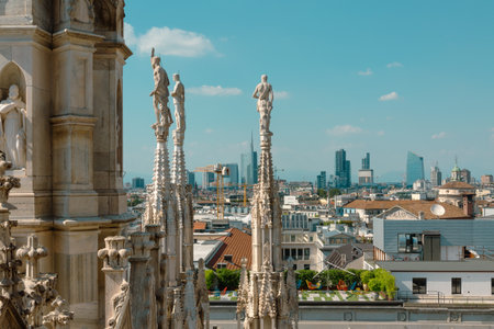 Milan Duomo statues overlook modern skyscrapers and city rooftopsの写真素材