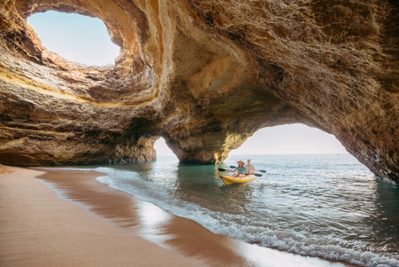 Couple on a kayak exploring the Benagil sea cave in Algarveの写真素材
