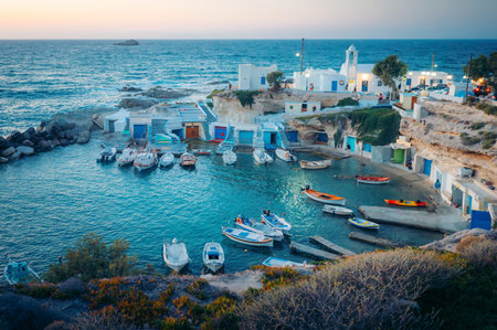 Fishing boats in a picturesque Greek village harbor at dusk, Milosの写真素材