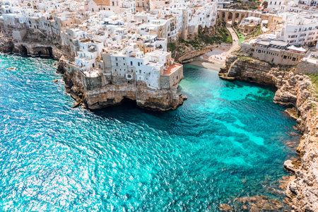 Aerial view of Polignano a Mare, Italy, with people enjoying the beach and seaの写真素材