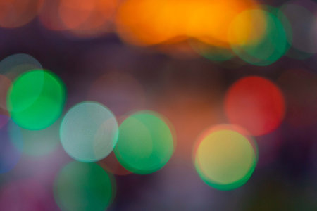 Image of blurred bokeh background with warm colorful lights.