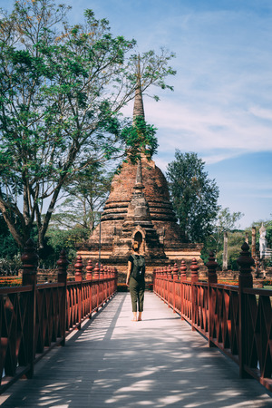 Temple complex in Sukhothai, Thailand. Beautiful historic park in the middle of Thailand. One man in the middle of the Temple. Shows the enormous scale of the temple.の写真素材