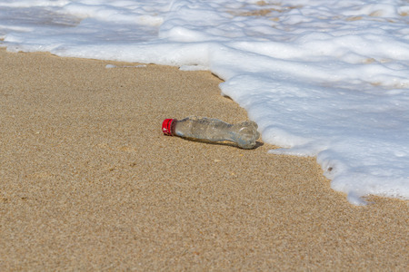 Beach pollution, plastic and waste from ocean on the beach.の写真素材
