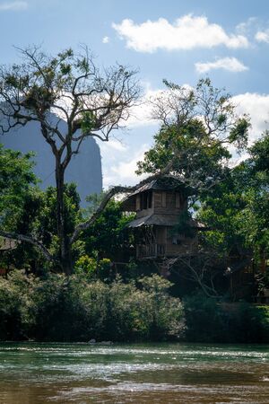 Stunning tree house in vang vieng just in front of nam song river. Hidden in the woods an oasis to relax from the stress and the tourists.の写真素材