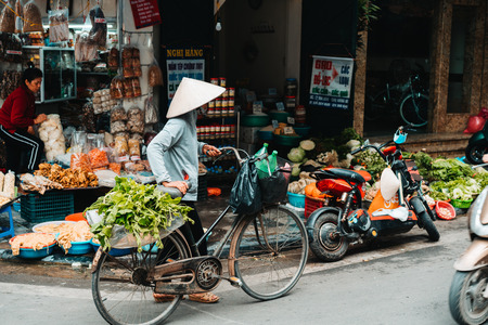 Hanoi, Vietnam, 12.20.18: Life in the street in Hanoi. Vendors try to sell their goods in the busy streets of Hanoiのeditorial素材