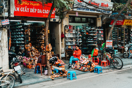 Hanoi, Vietnam, 12.20.18: Life in the street in Hanoi. Vendors try to sell their goods in the busy streets of Hanoiのeditorial素材