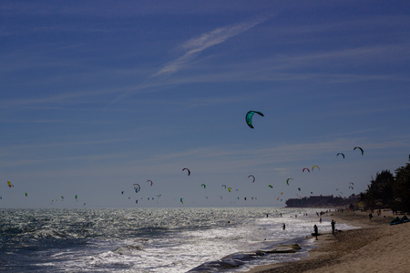 Kiteboarding, itesurfing at sunset in Mui Ne beach, Vietnam Phan Thiet.の写真素材