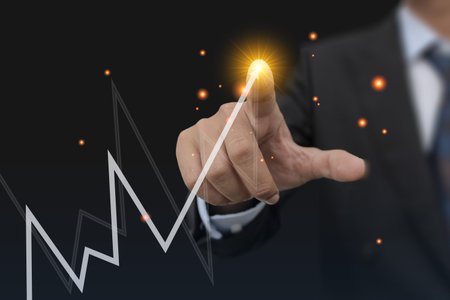 Close-up, A man holding Mobile and numbers 2022 is a startup concept driving global business in the new year.の写真素材