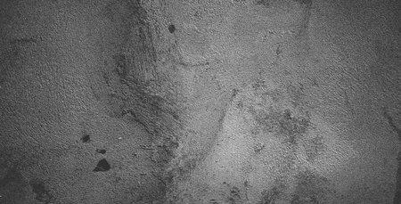 Black concrete wall or dark gray rough grainy stone texture background.の写真素材