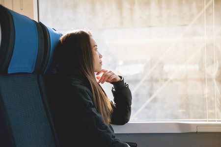 Cute young asian female tourists are sitting on the express train from Narita International Airport...