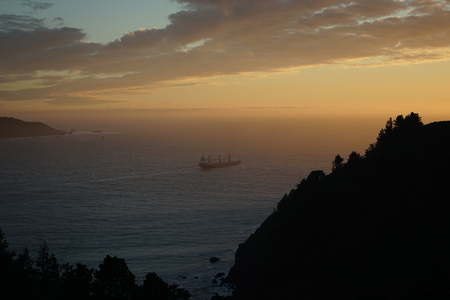 Container ship heading out to sea from San Francisco Californiaの写真素材