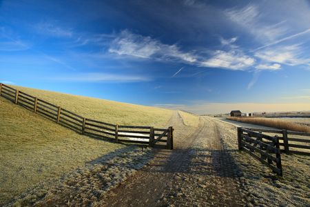 Open fence at the dike of the Waddenseaの写真素材