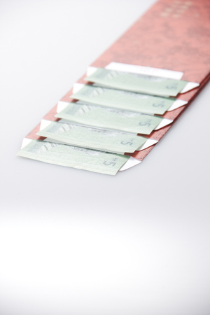 Red Ang Pao Packet with Malaysia Bank Note on right top in close up on 5 digitの写真素材