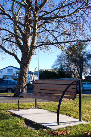 Bench under the tree at autumnの写真素材