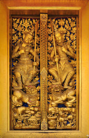 Ancient Golden carving wooden door of Thai temple in Bangkok, Thailandの写真素材