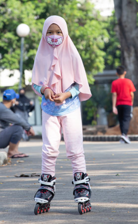 Jakarta, Indonesia - 28.10.2018 A little girl is rollerblading in the car free day areaのeditorial素材