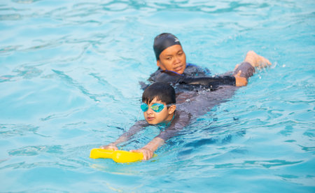 Jakarta, Indonesia - 10.11.2018 A theacher is training students to swimのeditorial素材