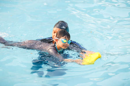 Jakarta, Indonesia - 10.11.2018 A theacher is training students to swimのeditorial素材