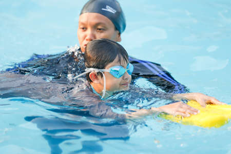 Jakarta, Indonesia - 10.11.2018 A teacher is training students to swimのeditorial素材