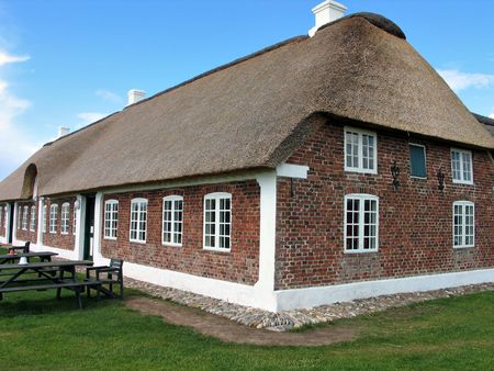 Typical country farmhouse with old style thatched straw roof in Denmarkの写真素材