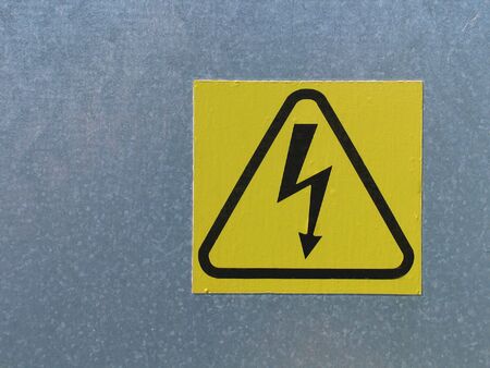 High voltage electricity warning sign on a wall