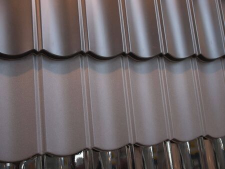 Fragment of modern metal roof tiles in different colorsの写真素材