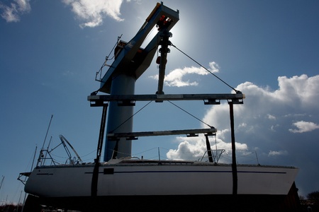 Sailboat lift up by a heavy industrial boat lifter for maintenance                             の写真素材