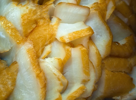 Display of fresh seafood smoked white fish fillets on ice cubes in a delicatesen shopの写真素材