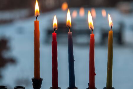 Beautiful Hanukkah menorah chanukkiah with glowing candles in a window