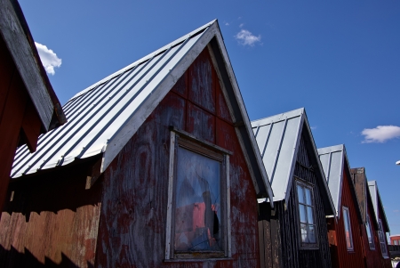 Beautiful red fishing huts on the coast Faaborg Denmarkのeditorial素材