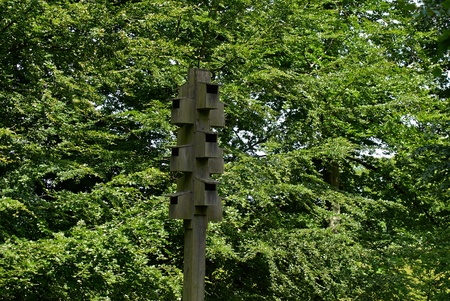 Wooden bird house on a tree in a forest park