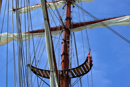 Sailing masts of traditional vintage wooden tallships sky backgroundの写真素材