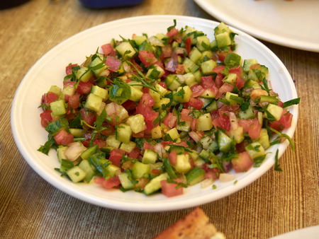 Bowl with classic traditional freshly cut  Israeli saladの写真素材