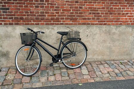 Vintage Classical  Black Bicycle in front of an old house Denmarkの写真素材