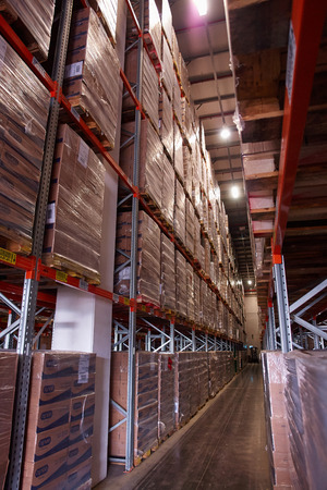 Large modern warehouse logistics center with rows of shelves with boxesのeditorial素材