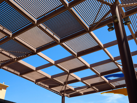 Modern design pergola arbor made wood and metal with clear blue summer sky backgroundの写真素材