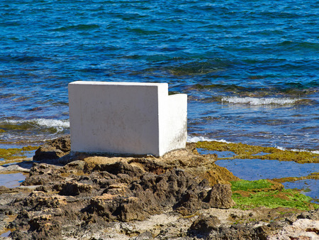 Bench made of stone in beautiful popular summer tourism destination Torrevieja beach, Costa Blanca, Valencia, Spainの写真素材