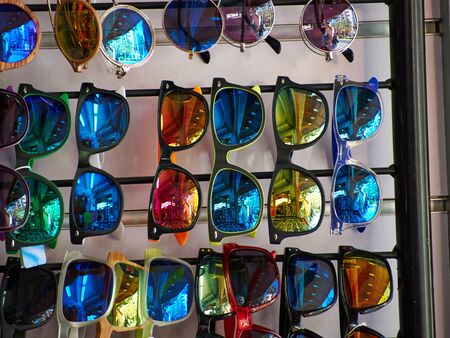 Wide selection of trendy fashionable colorful sun glasses on sales displayの写真素材