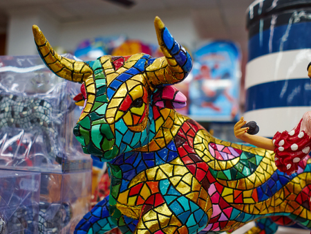 Miniature colorful statue of bull in Gaudi style - traditional classical souvenir in a market Spainの写真素材