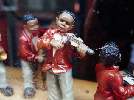 Vintage figurines of black musicians playing Jazz music on display in an antiques shopの写真素材