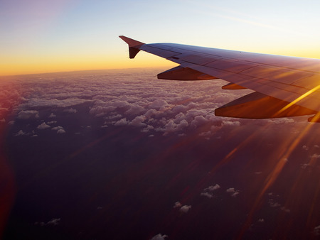 Airplane flying above clouds in clear blue sky great travel transportation background image