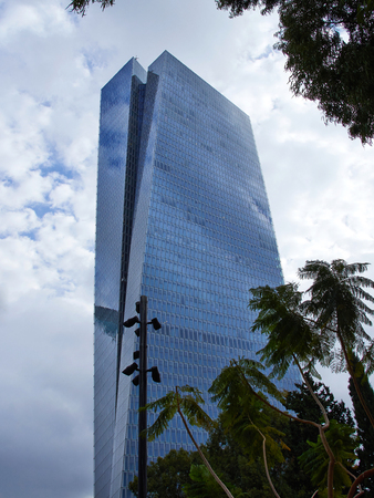 Modern trendy futuristic design city urban skyscraper in low angle view