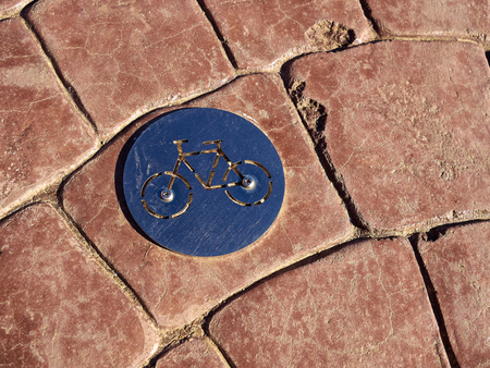 Bicycle bikes lane path logo made of metal on a roadの写真素材