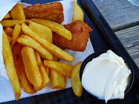 Traditional classical British English Fish and Chips served on a tray by the oceanの写真素材